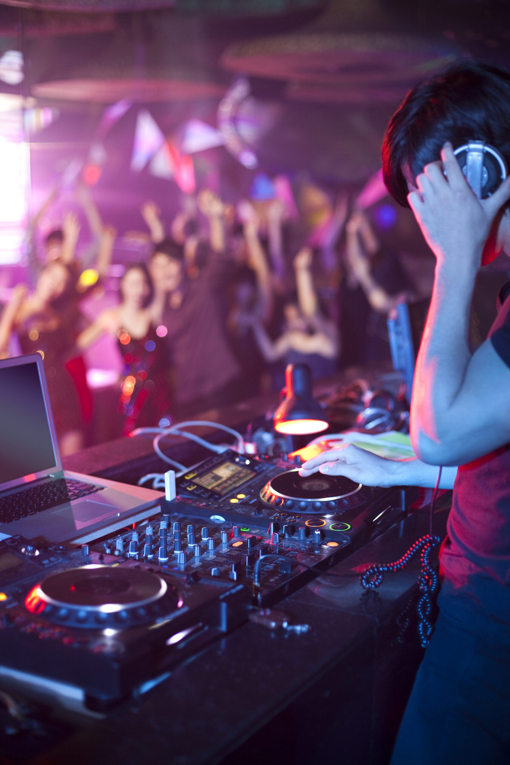 Chinese DJ doing record scratching in nightclub
